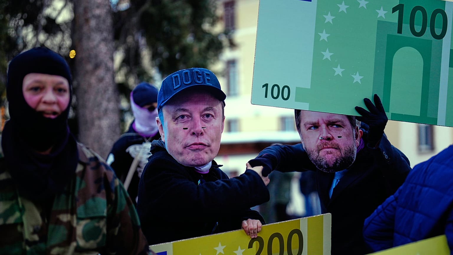 FILE - People with Elon Musk masks attend a demonstration against US President Donald Trump at the World Economy Forum in Switzerland. 18 January 2026