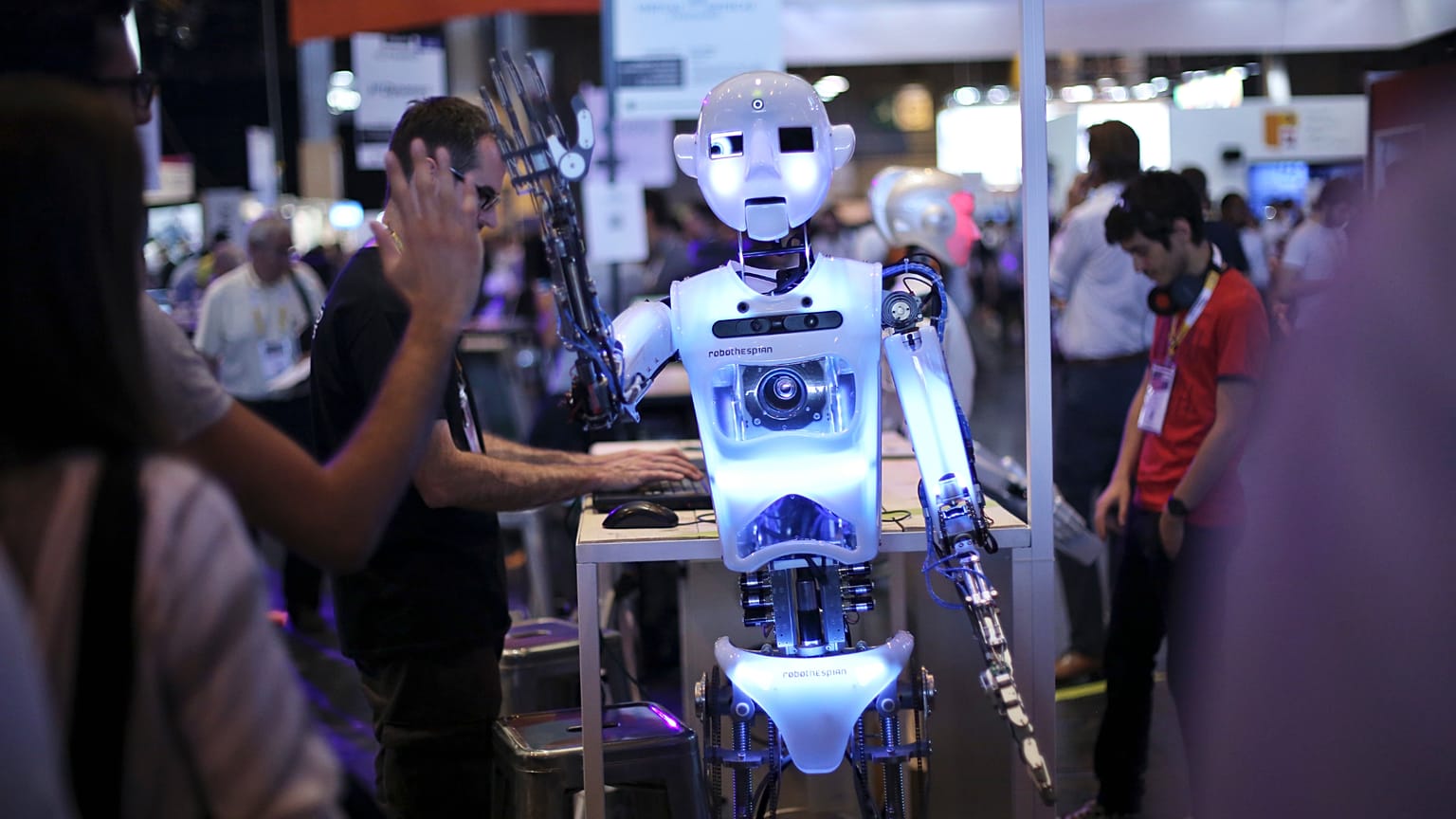 A robot claps in the hand of a visitor at the Vivatech, a gadgets show in Paris, France. 16 June 2017.