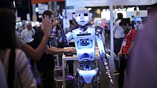 A robot claps in the hand of a visitor at the Vivatech, a gadgets show in Paris, France. 16 June 2017.