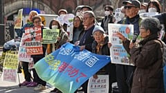 Protesters hold a sign during a rally against the restart of of the No. 6 reactor at the Kashiwazaki-Kariwa nuclear power plant, in front of Tokyo Electric Power Company Holdi