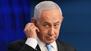 Israeli Prime Minister Benjamin Netanyahu adjusts the headphones during a press conference in Jerusalem, 7 December, 2025
