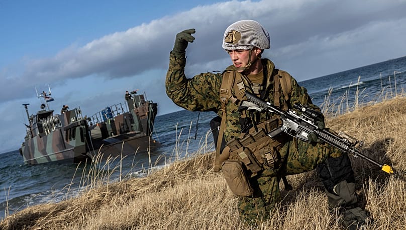 A US marine lands near Sandstrand, Norway, March 21, 2022, during the military exercise Cold Response 22. (NATO via AP)
