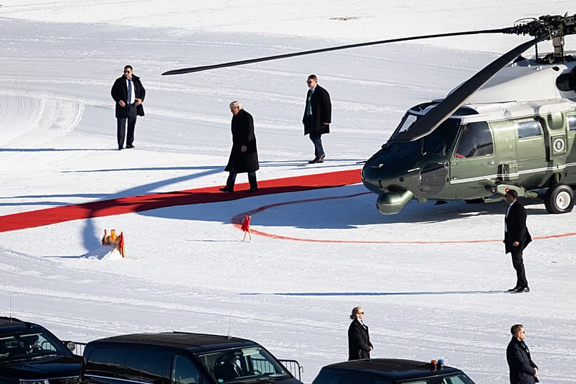 US President Donald Trump walks out of the Marine One helicopter as he arrives for the 56th annual meeting of the World Economic Forum in Davos, 21 January 2026
