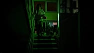 A woman goes to see her neighbour during a blackout in Kyiv, 13 January, 2026