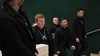 Ukraine's President Volodymyr Zelenskyy walks up a stairwell as he arrives for the Annual Meeting of the World Economic Forum in Davos, 22 January 2026