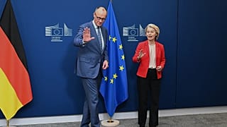 European Commission President Ursula von der Leyen, right, greets Germany's Chancellor Friedrich Merz prior to a meeting at EU headquarters in Brussels, Jan. 22, 2026