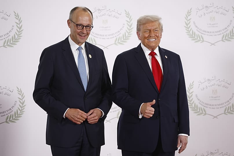 President Donald Trump and German Chancellor Friedrich Merz pose during the family picture at the Gaza International Peace Summit, in Sharm el-Sheikh, Egypt, October 2025.