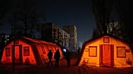 People walk past emergency tents set to warm up in Kyiv, 21 January, 2026