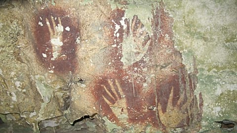 This undated image provided by Maxime Aubert shows handprints with sharpened fingertips in the Maros region of Sulawesi, Indonesia.