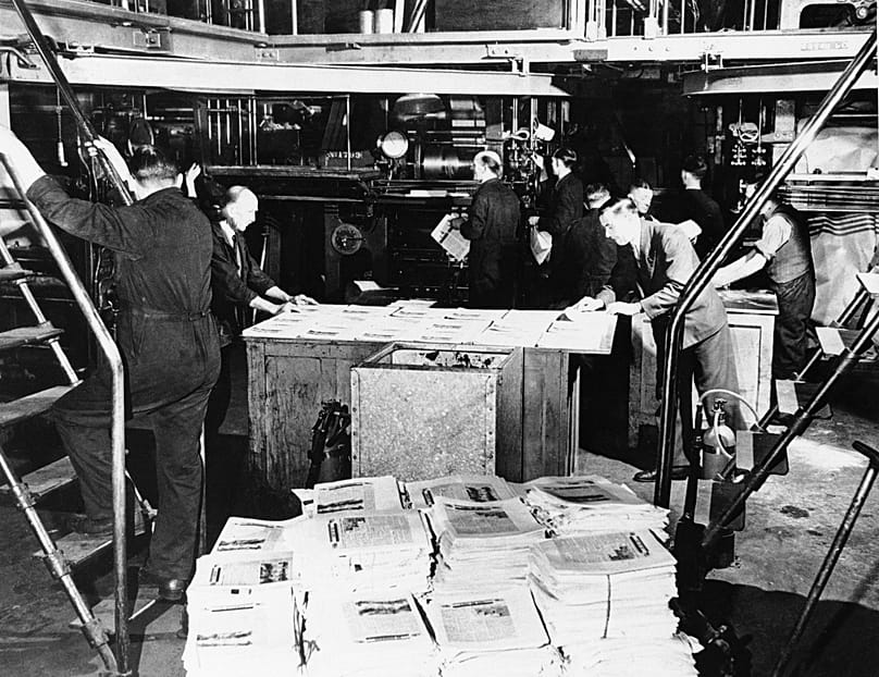 Leaflets are counted and stacked after coming off the press in the UK, 25 July, 1944