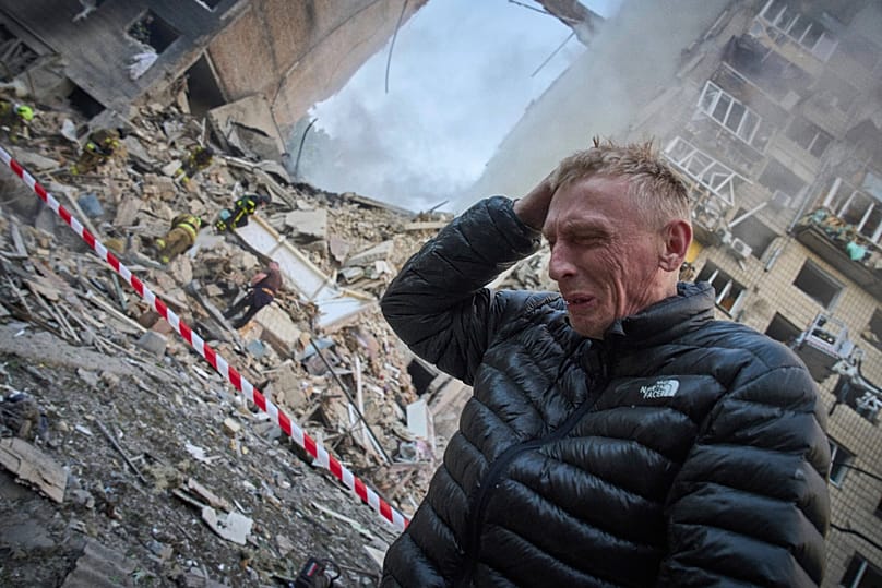 A resident reacts after a Russian missile hit a multi-storey apartment during Russia's combined missile and drone air attack in Kyiv, 17 June, 2025