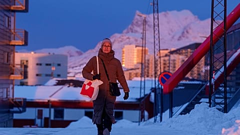 A woman walks on a street at sunset in Nuuk, Greenland, on Wednesday, Jan. 21, 2026.