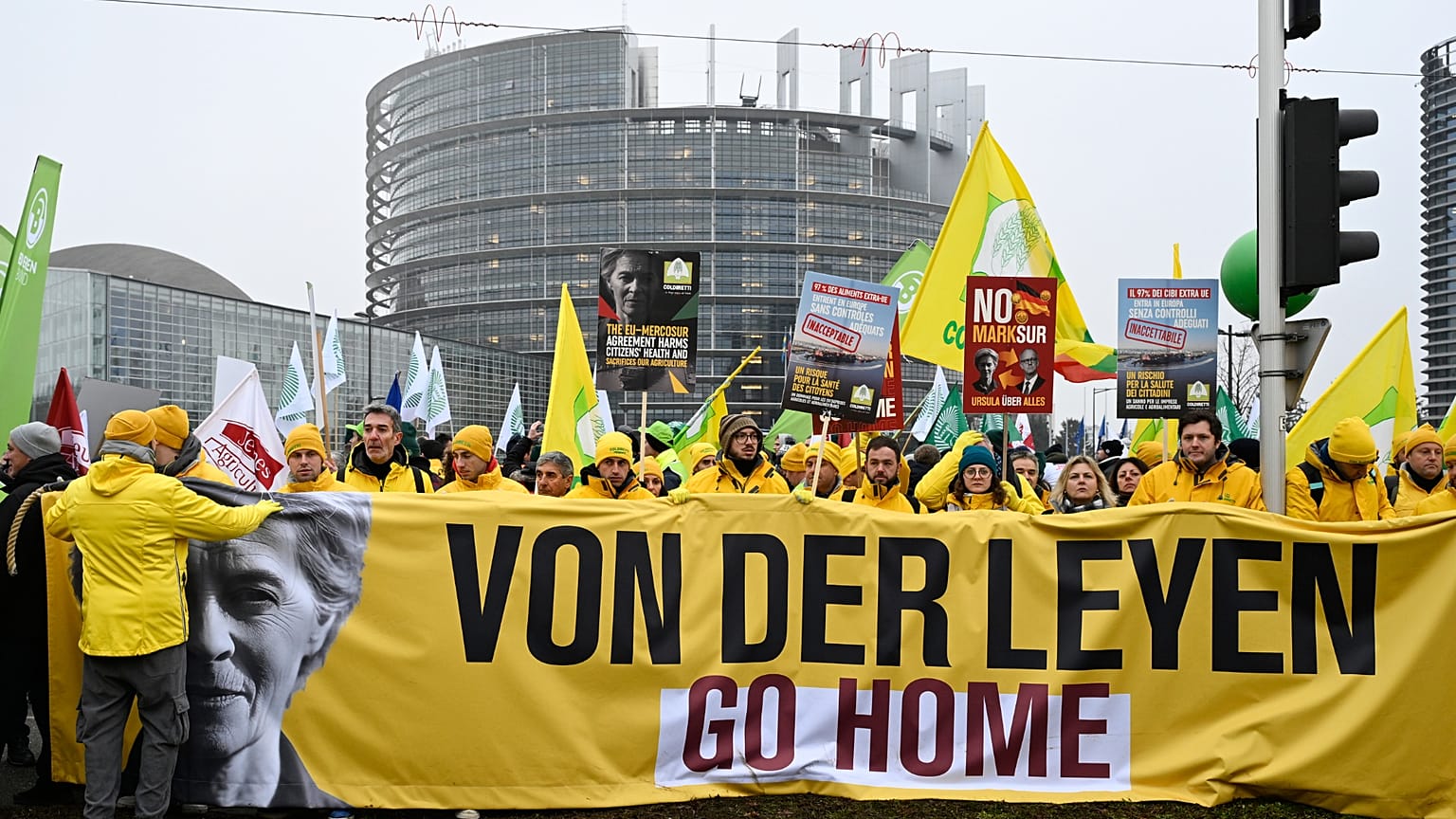 Farmers protest, as they stand in front of a banner of European Commission President Ursula von der Leyen, during a demonstration in France. 20 January 2026.