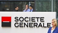 FILE - In this 11 August 2011 file photo, employees stand at the entrance of the Societe General bank headquarters in Paris.
