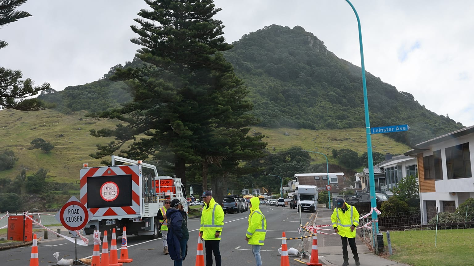 Emergency workers attend the scene after a landslide hit a campground at Mt. Maunganui, New Zealand