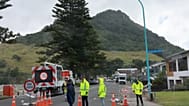Emergency workers attend the scene after a landslide hit a campground at Mt. Maunganui, New Zealand