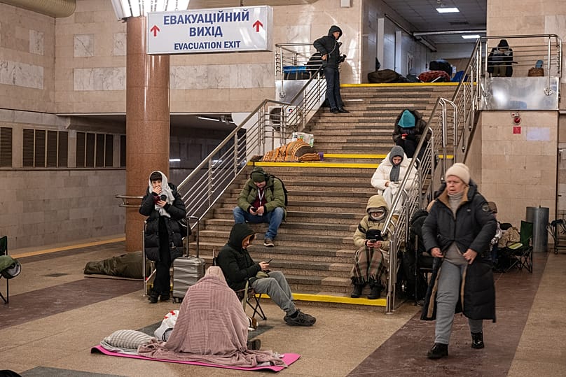 FILE: People take shelter in a subway station during Russia's night missile and drone attack in Kyiv, 20 January 2026
