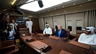 Reporters look on as President Donald Trump, seated center, meets with Emir of Qatar Sheikh Tamim bin Hamad al-Thani