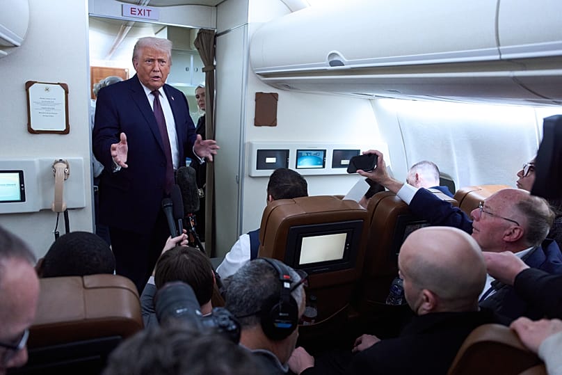 US President Donald Trump speaks with reporters aboard Air Force One after leaving the World Economic Forum in Davos, 22 January, 2026