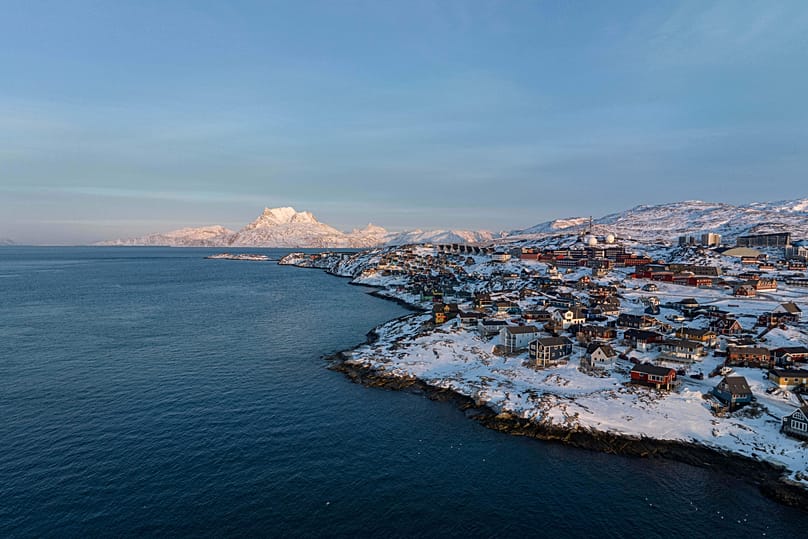 Houses are seen near the coast of a sea inlet of Nuuk, 25 January, 2026
