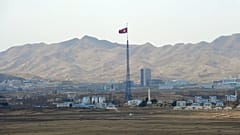 Die Flagge Nordkoreas weht auf einem Turm hoch über dem Dorf Ki Jong Dong, 25. März 2012