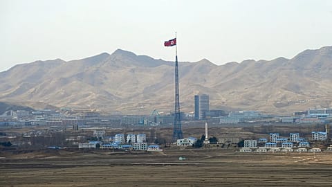 North Korea's flag flies on a tower high above the village of Ki Jong Dong, 25 March, 2012
