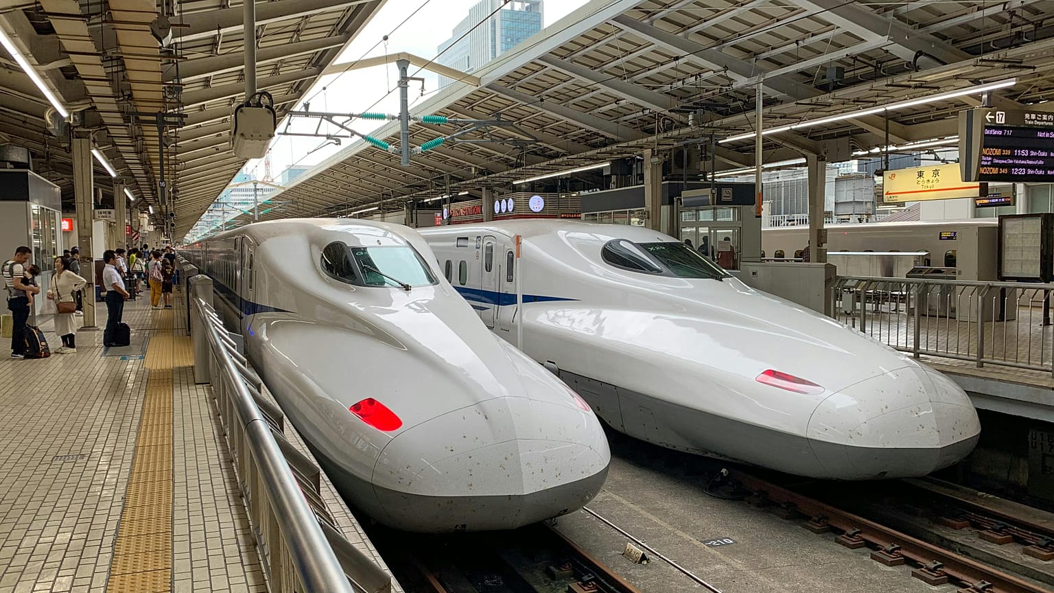 Two white bullet trains in a station in Tokyo, Japan