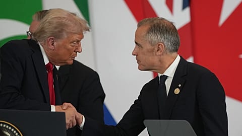 US President Donald Trump speaks to Canada's Prime Minister Mark Carney during a summit to support ending war in Gaza between Israel and Hamas held in Egypt on 13 Oct 2025
