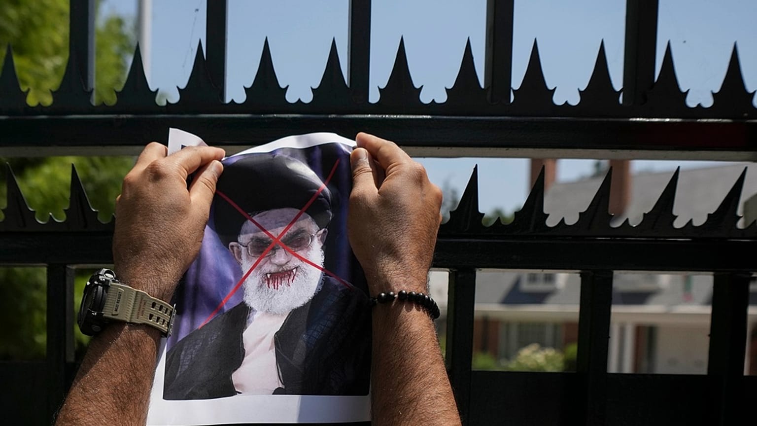 A defaced poster of Ayatollah Ali Khamenei is placed on a gate of Iran's embassy, during a rally in support of anti-government protests in Iran, in Santiago, 20 January 2026