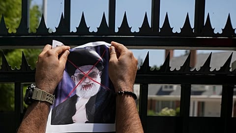 A defaced poster of Ayatollah Ali Khamenei is placed on a gate of Iran's embassy, during a rally in support of anti-government protests in Iran, in Santiago, 20 January 2026