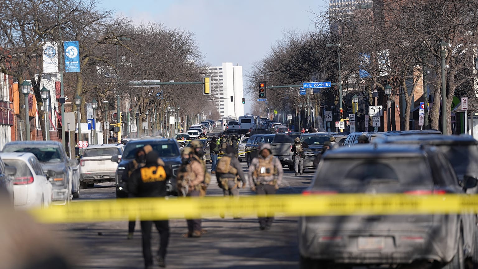 Federal agents stand near the site of a shooting Saturday, 24 January 2026, in Minneapolis.