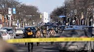 Federal agents stand near the site of a shooting Saturday, 24 January 2026, in Minneapolis.