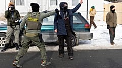 A federal immigration uses a chemical agent on a observer after detaining a man and his child on Thursday, Jan. 22, 2026, in Minneapolis.