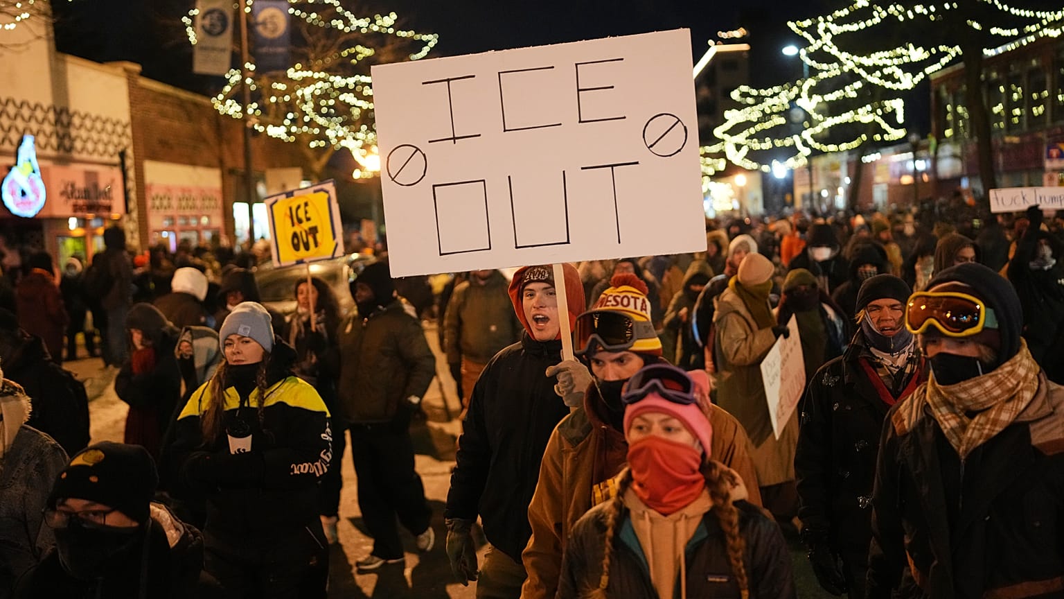 A person holds a sign during a vigil for 37-year-old Alex Pretti, who was fatally shot by a US Border Patrol officer, Saturday, 24 Jan 24, 2026, in Minneapolis