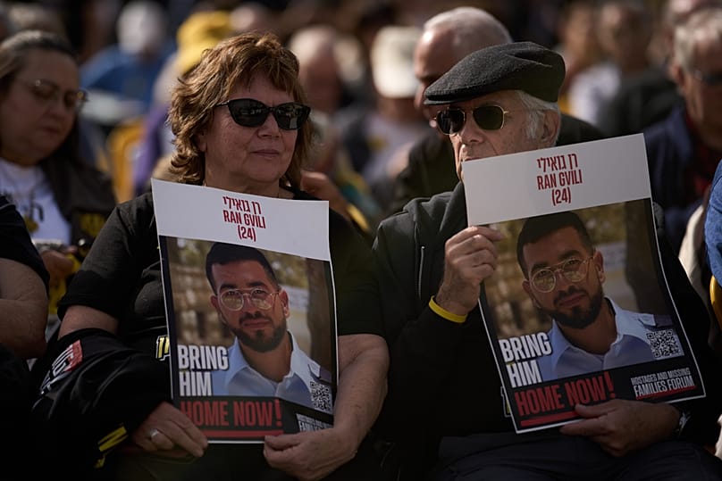 People hold signs of Israeli soldier Ran Gvili, during a rally calling for his return in Tel Aviv, Israel, Friday, Jan. 23, 2026.