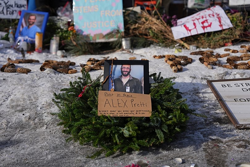 A makeshift memorial is placed where Alex Pretti was fatally shot by a U.S. Border Patrol officer yesterday, in Minneapolis, Sunday, Jan. 25, 2026