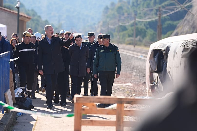 Spain's King Felipe VI and Queen Letizia visit the site of a train collision in Adamuz, southern Spain, Tuesday, Jan. 20, 2026.