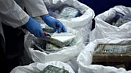 Police open a packet with cocaine as a large supply recently seized is displayed to the press in Lisbon, 8 January, 2020