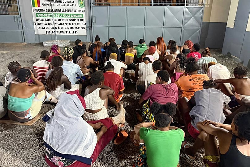 In this photo released by INTERPOL, victims of human trafficking are detained at an office in Dakar, Senegal, Monday, Nov. 17, 2025.
