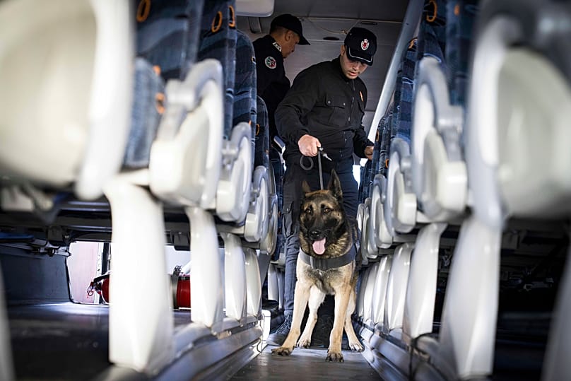 An Interpol officer search a passengers bus in Tanger, 12 November, 2025