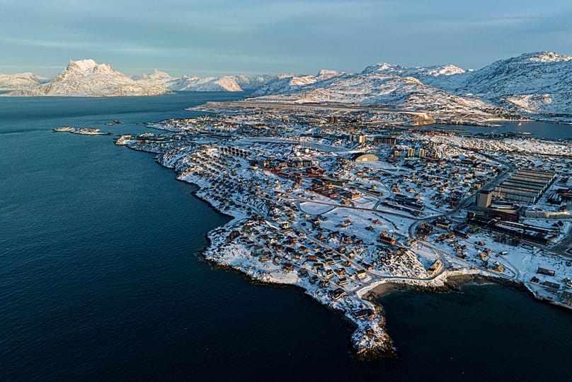 Houses are seen near the coast of a sea inlet of Nuuk, 25 January, 2026