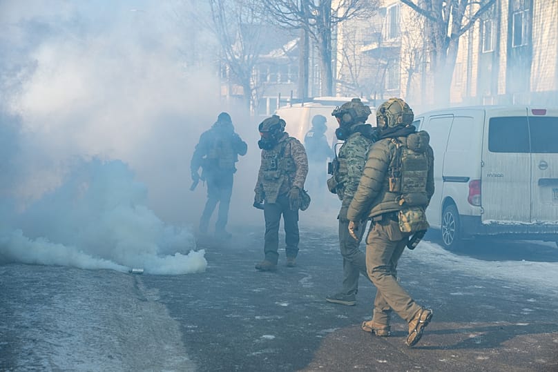 ICE agents walk through a cloud of their own tear gas at the scene where federal agents fatally shot Alex Pretti in Minneapolis, 24 January 2026