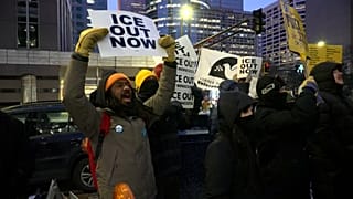 A man holds a placard reading ‘ICE out now’ during a protest condemning ICE’s deadly actions, Minneapolis, USA, Jan.26, 2026