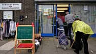 FILE: People line up at the Community Food Hub in Hackney, London, Thursday, June 13, 2024.