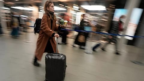 Mulher passeia numa estação de comboios no Reino Unido, fotografia de arquivo de 2023.