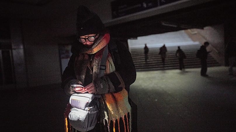 FILE: Bonnie uses a cell phone light as she walks through the Wannsee public transport station in Berlin, Germany, Saturday, Jan. 3, 2025,