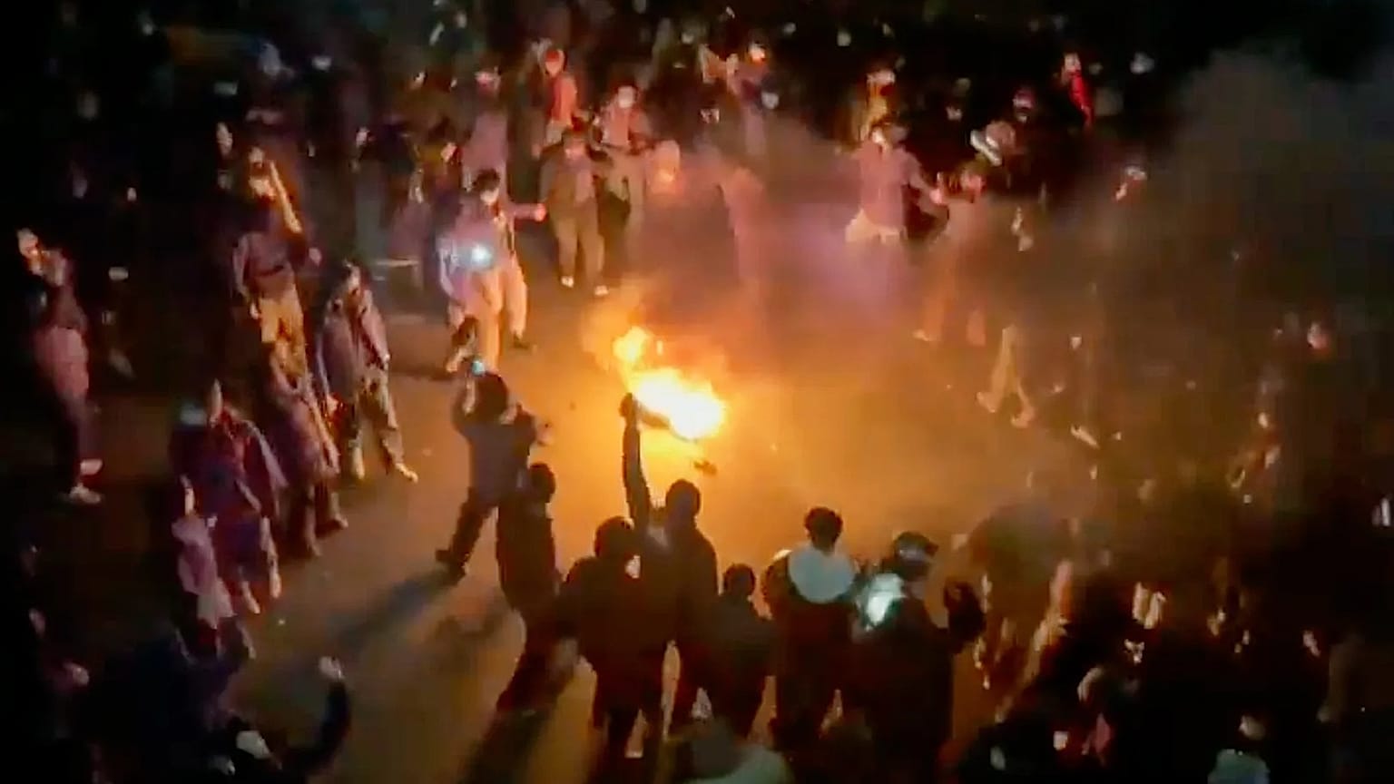 In this frame grab from footage circulating on social media protesters dancing and cheering around a bonfire in Tehran, 9 January, 2026
