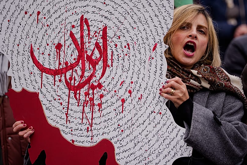 A woman holds a map of Iran during a rally in support of anti-government protests in Iran in Bucharest, 24 January, 2026