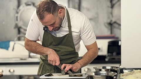 Chef Ilias Kyiazoli of Nonnas Athens restaurant in Plaka cooks lionfish