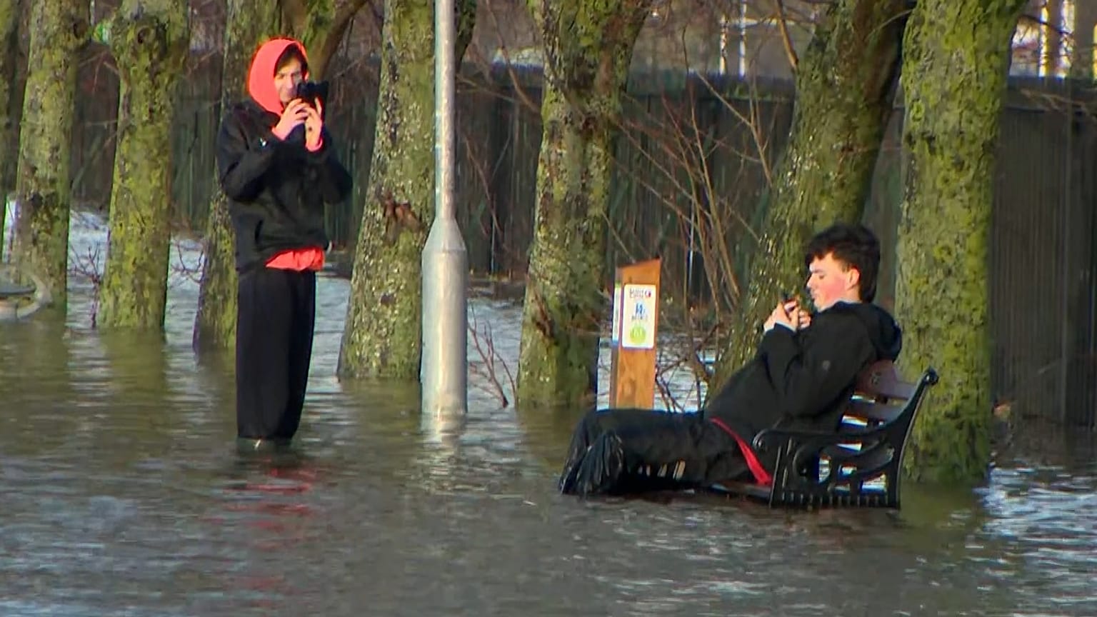A man sits on a bench during flooding caused by Storm Chandra, Dublin, Ireland, Jan. 27, 2026.
